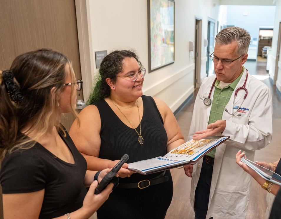Two women talking to a doctor.